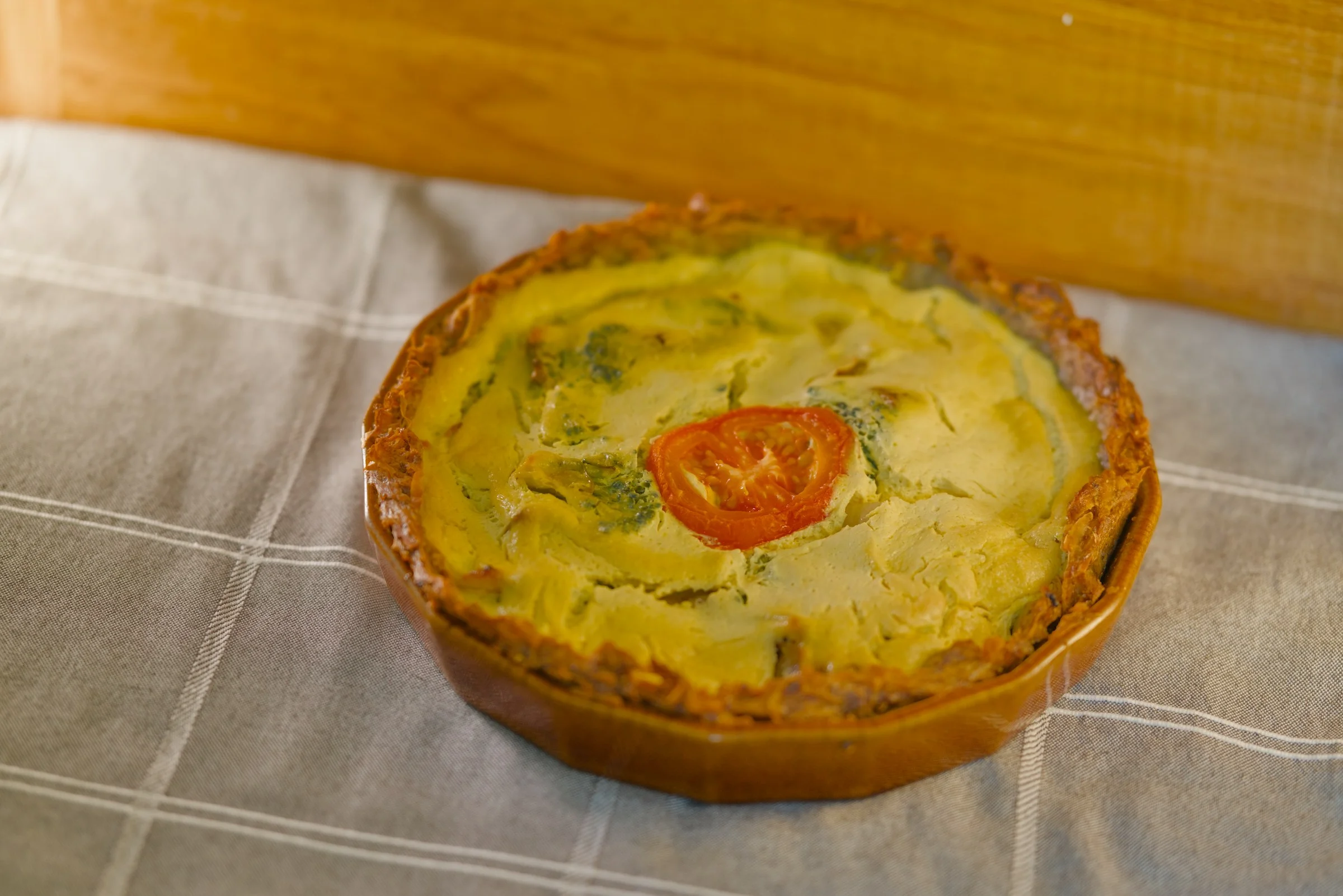 Slices of broccoli quiche arranged on a serving board.